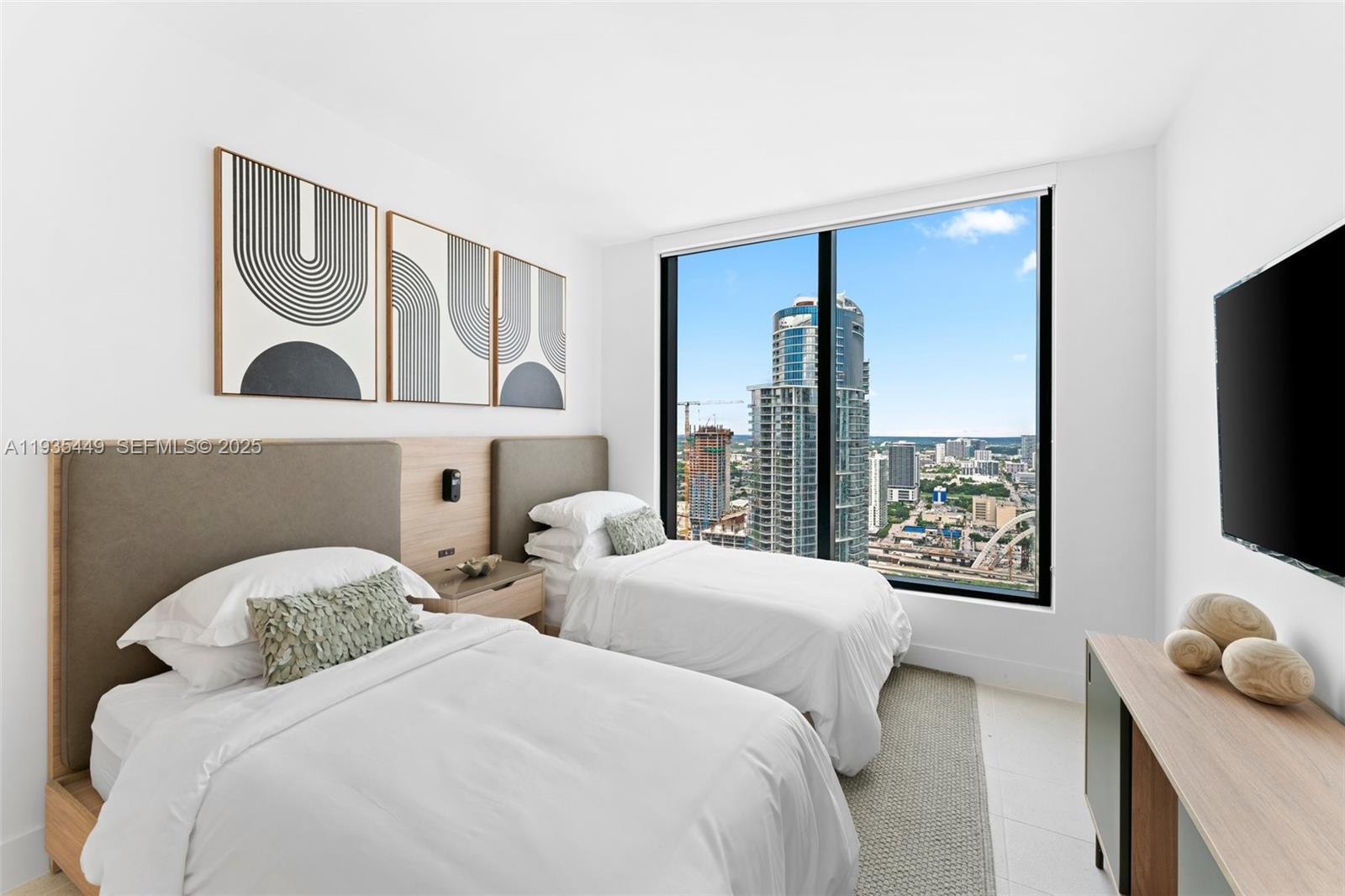 159 Northeast 6th Street, Unit 4415 Miami, FL 33132 - Photo 11 of 47 a bedroom with two beds and a flat screen tv