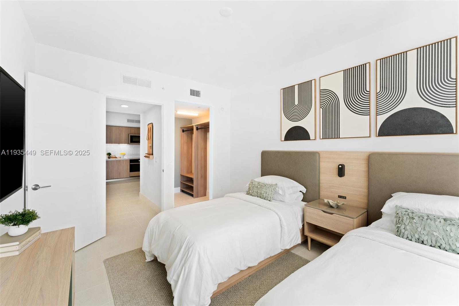 159 Northeast 6th Street, Unit 4415 Miami, FL 33132 - Photo 13 of 47 a bedroom with two beds and painting on the wall