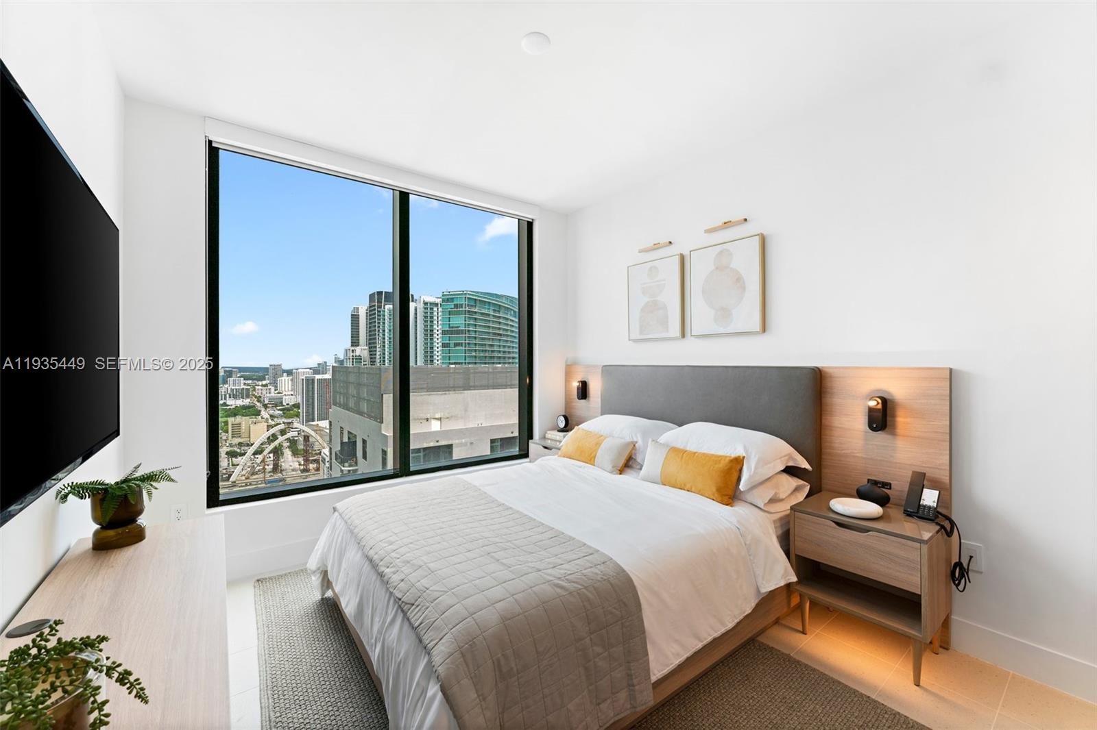 159 Northeast 6th Street, Unit 4415 Miami, FL 33132 - Photo 16 of 47 a bedroom with a bed and a flat tv screen on dresser