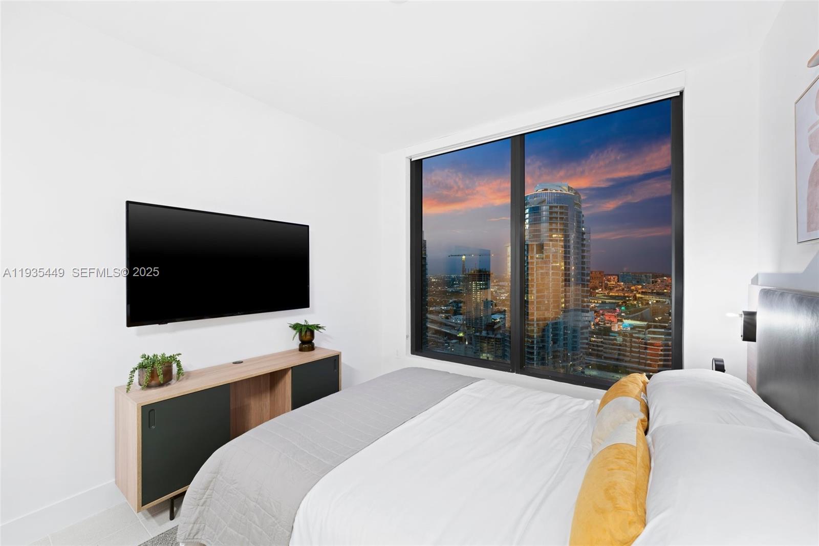 159 Northeast 6th Street, Unit 4415 Miami, FL 33132 - Photo 17 of 47 a bedroom with a bed and a flat screen tv