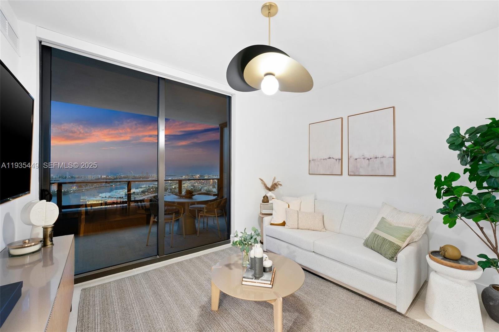 159 Northeast 6th Street, Unit 4415 Miami, FL 33132 - Photo 22 of 47 a living room with furniture potted plant and a large window