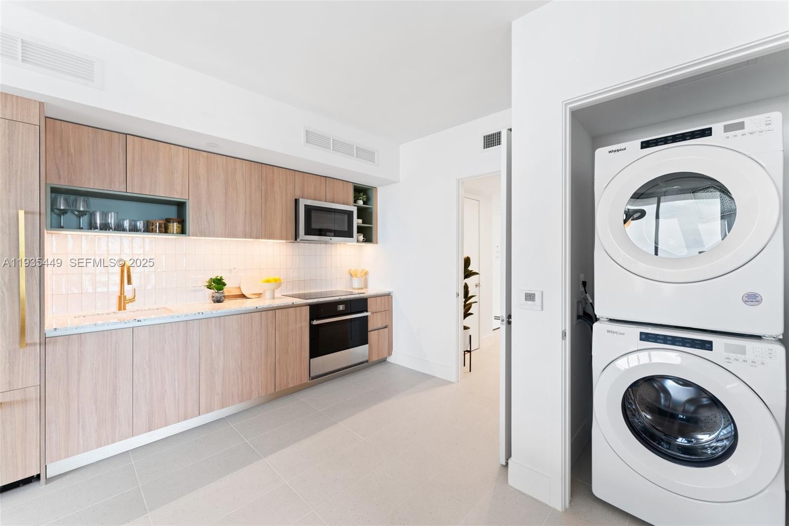 159 Northeast 6th Street, Unit 4415 Miami, FL 33132 - Photo 30 of 47 a kitchen with granite countertop a sink a stove and a refrigerator