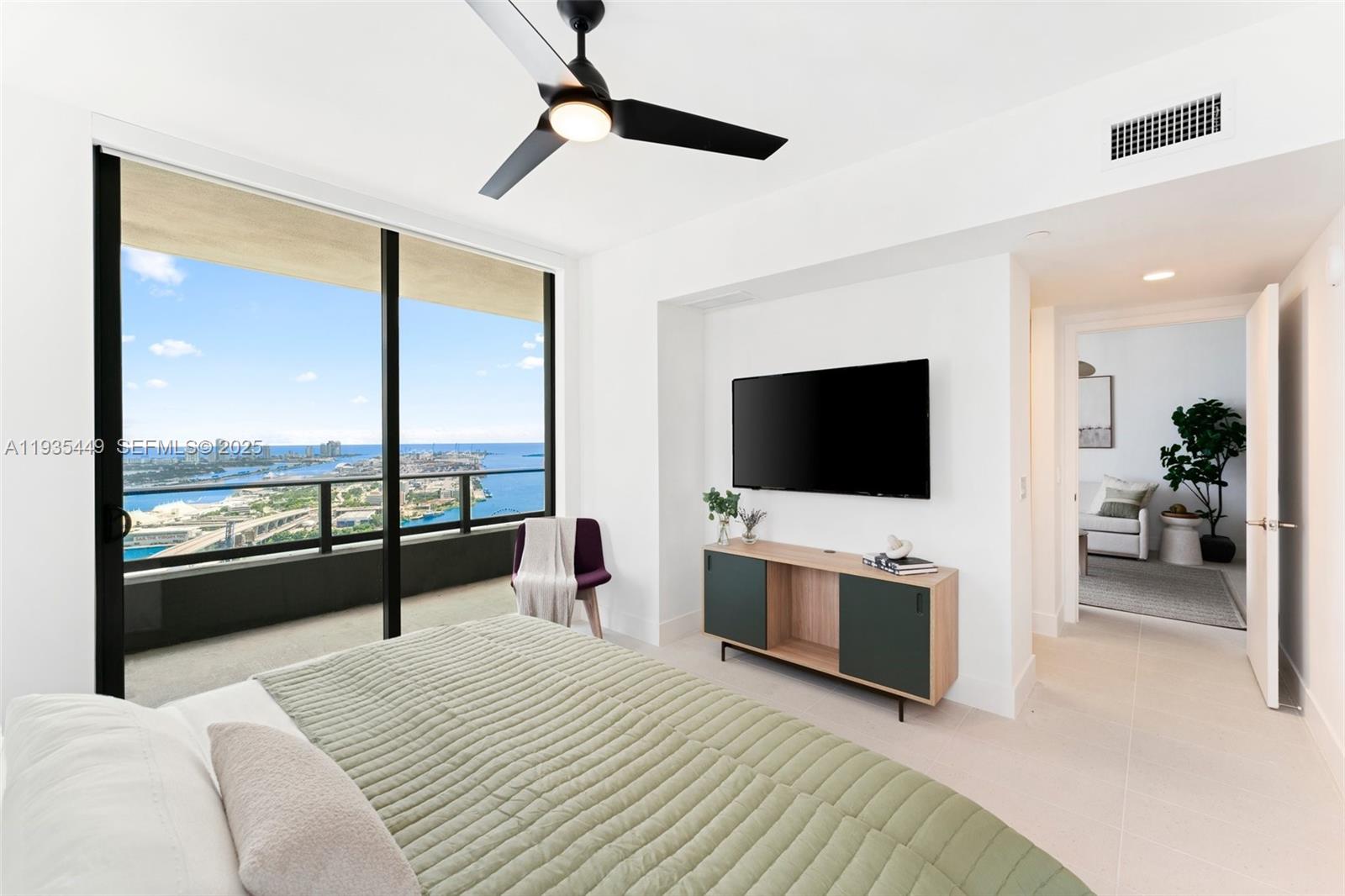 159 Northeast 6th Street, Unit 4415 Miami, FL 33132 - Photo 9 of 47 a bedroom with a bed and a flat screen tv