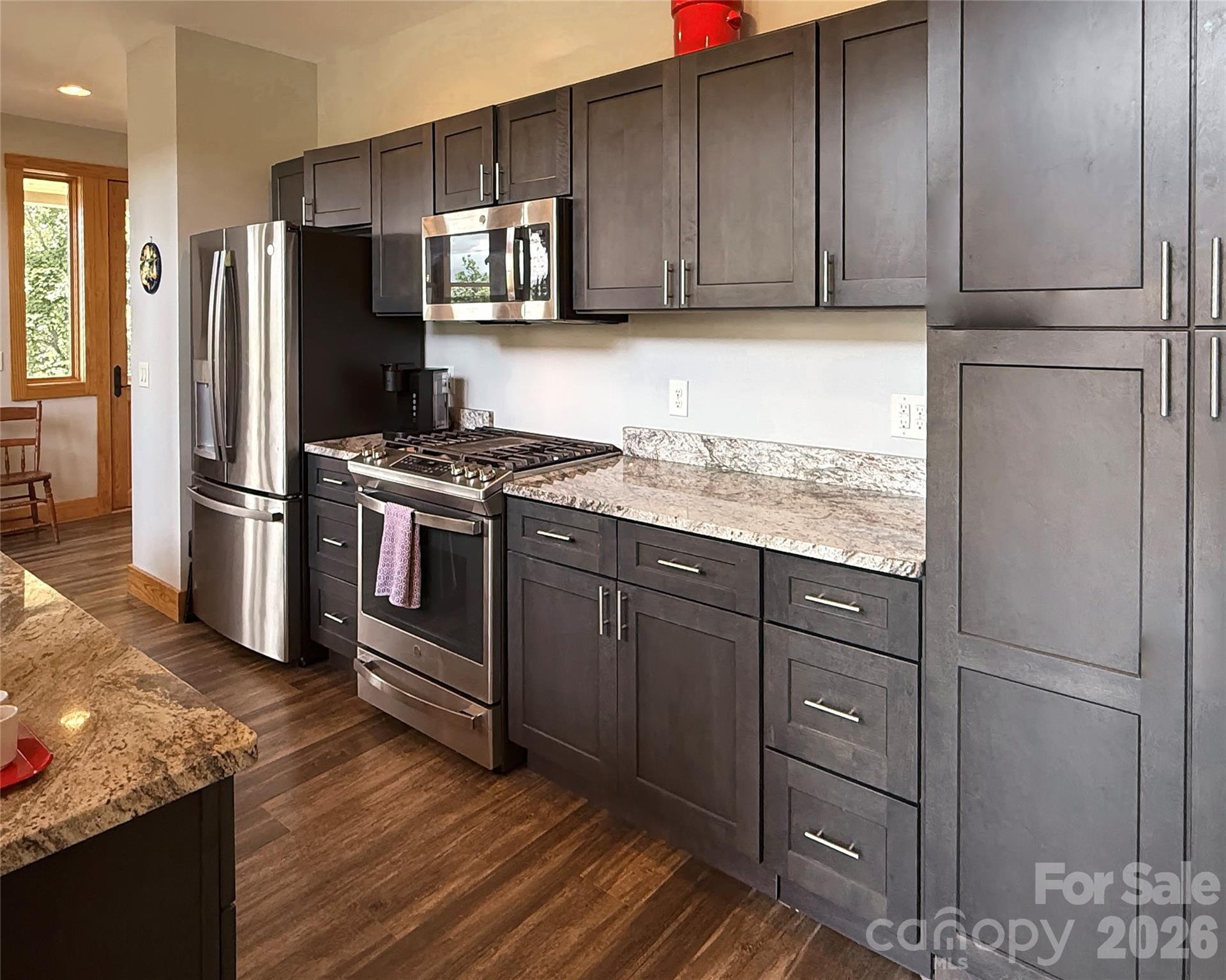 1856 Cabbage Patch Road Burnsville, NC 28714 - Photo 21 of 46 a kitchen with stainless steel appliances granite countertop a refrigerator stove and sink
