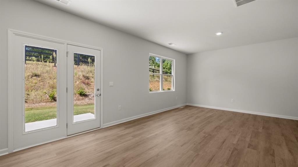 519 Oak View Lane Dallas, GA 30157 - Photo 14 of 35 an empty room with wooden floor and windows