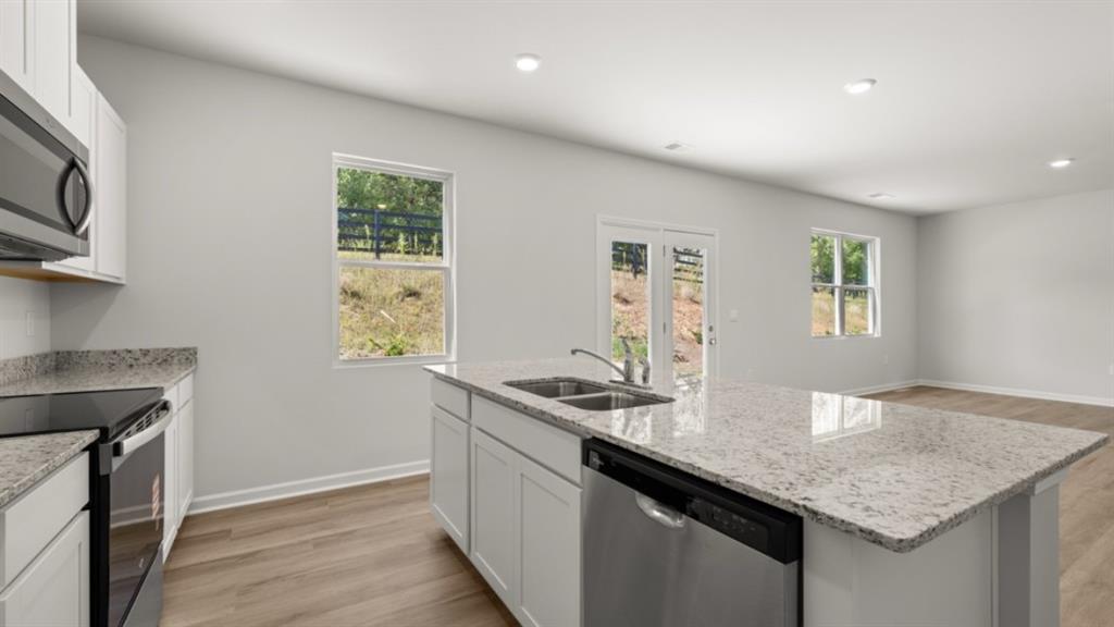 519 Oak View Lane Dallas, GA 30157 - Photo 9 of 35 a kitchen with granite countertop cabinets stainless steel appliances a sink and a window