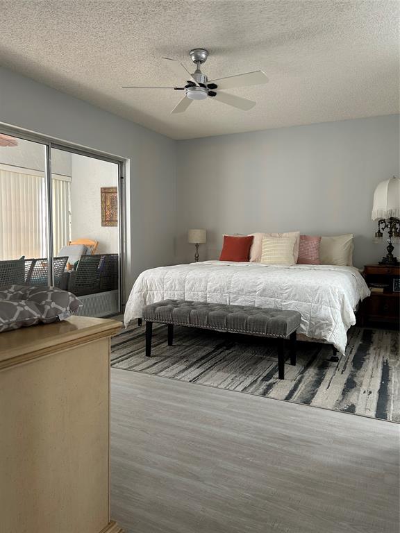 6770 Royal Palm Boulevard, Unit 301L Margate, FL 33063 - Photo 13 of 32 a bedroom with a bed and a couch