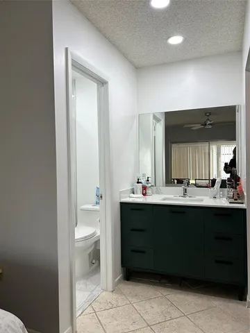 a white toilet sitting next to a bath tub