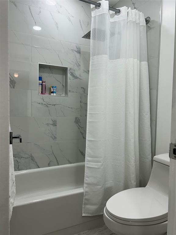6770 Royal Palm Boulevard, Unit 301L Margate, FL 33063 - Photo 16 of 32 a white toilet sitting next to a bath tub