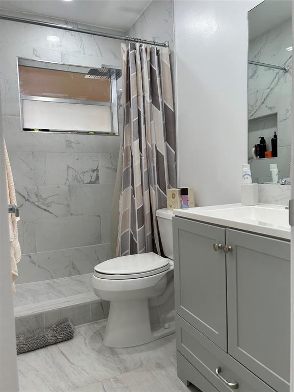 6770 Royal Palm Boulevard, Unit 301L Margate, FL 33063 - Photo 18 of 32 a bathroom with a sink toilet and shower