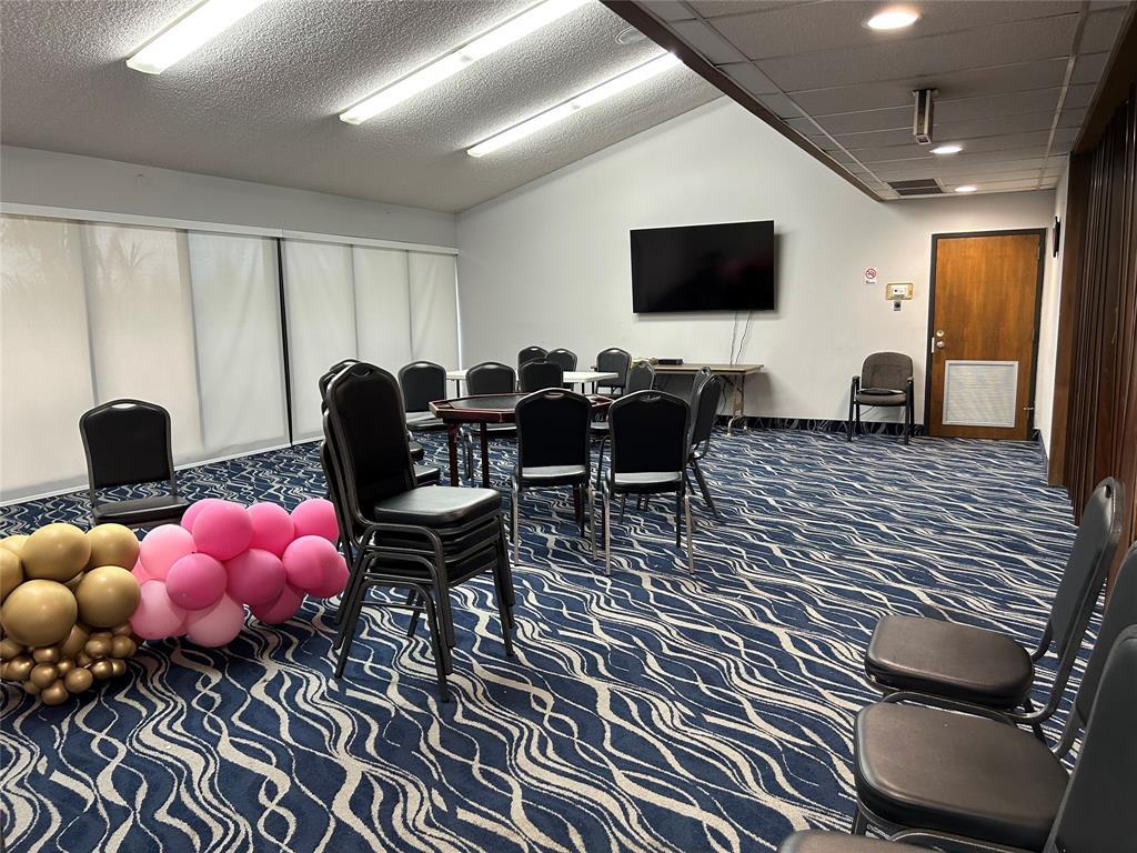 6770 Royal Palm Boulevard, Unit 301L Margate, FL 33063 - Photo 22 of 32 a living room with furniture and a flat screen tv