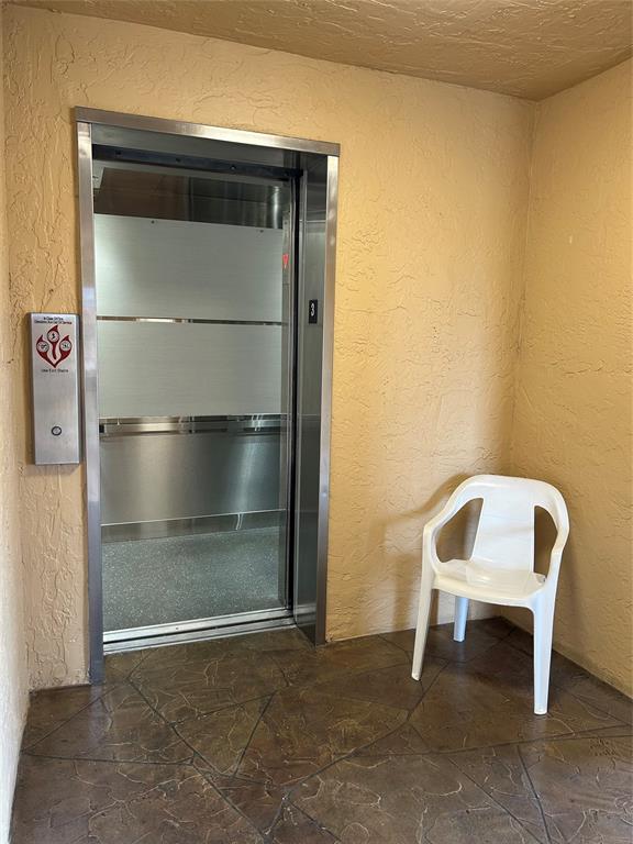 6770 Royal Palm Boulevard, Unit 301L Margate, FL 33063 - Photo 31 of 32 a chair and a table in a room