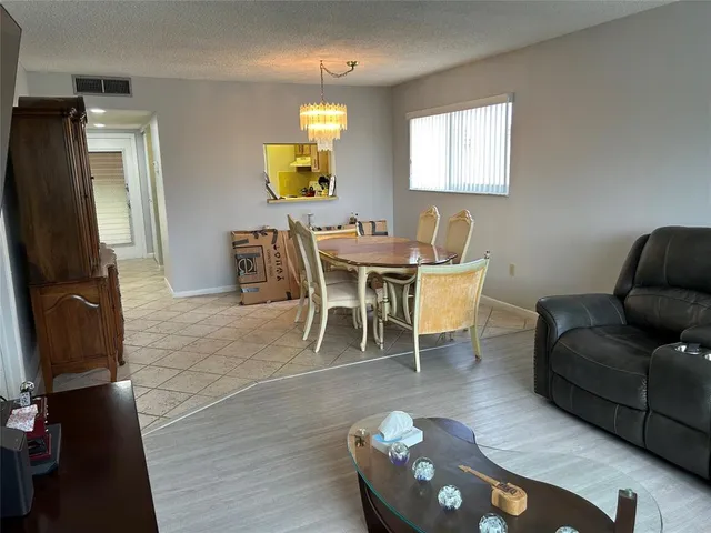 a view of a dining room with furniture and a window