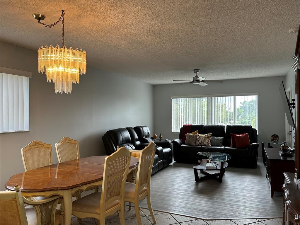 6770 Royal Palm Boulevard, Unit 301L Margate, FL 33063 - Photo 6 of 32 a living room with furniture chandelier and a chandelier