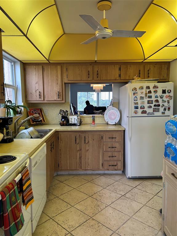 6770 Royal Palm Boulevard, Unit 301L Margate, FL 33063 - Photo 10 of 32 a kitchen with a sink a stove and cabinets