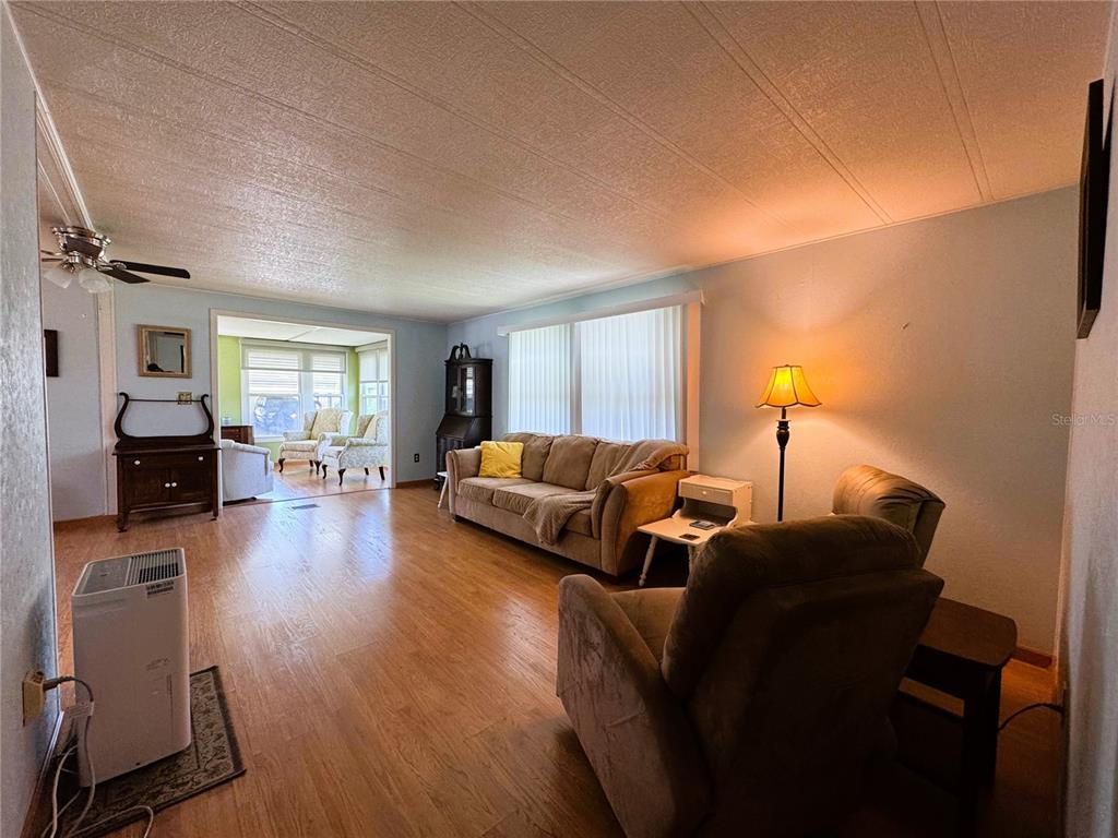 151 Hibiscus Way Leesburg, FL 34748 - Photo 11 of 30 a living room with furniture and a wooden floor