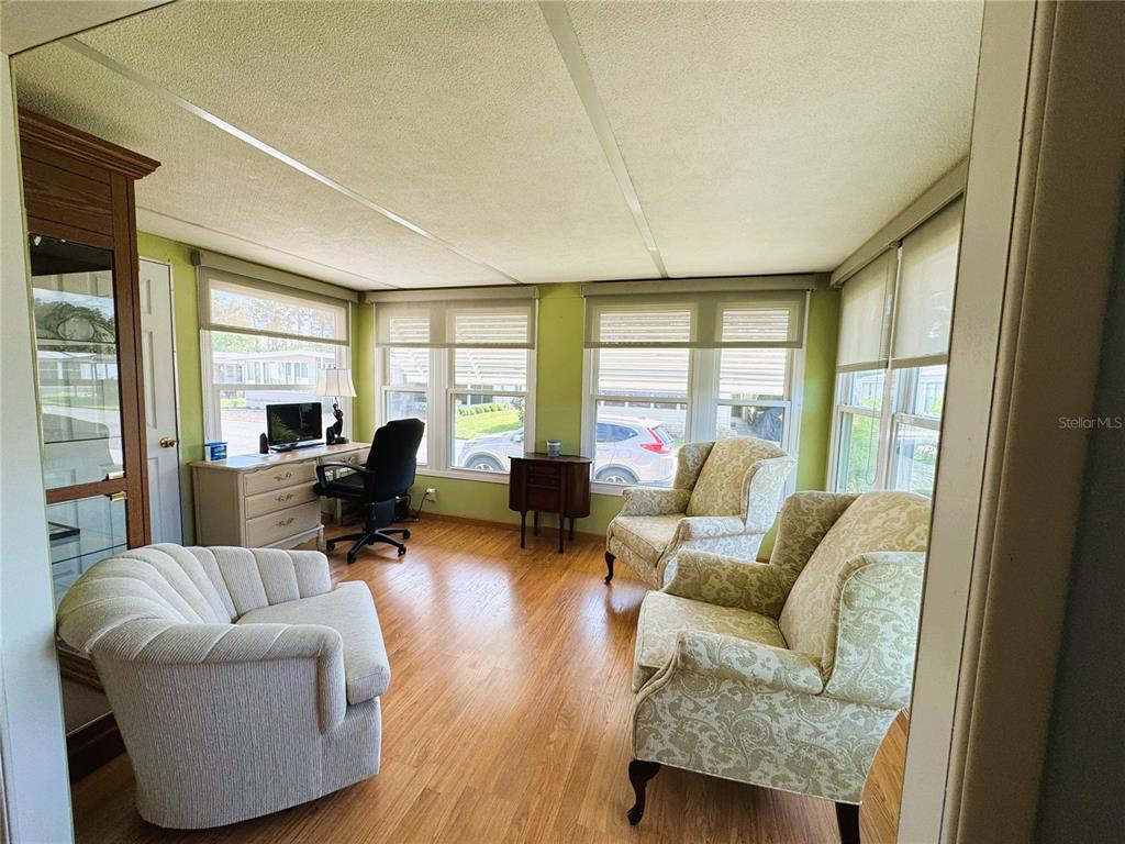 151 Hibiscus Way Leesburg, FL 34748 - Photo 12 of 30 a living room with furniture and a large window