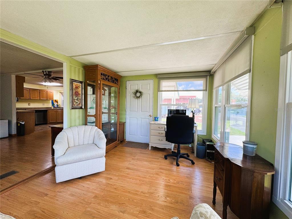 151 Hibiscus Way Leesburg, FL 34748 - Photo 13 of 30 a living room with furniture and a flat screen tv