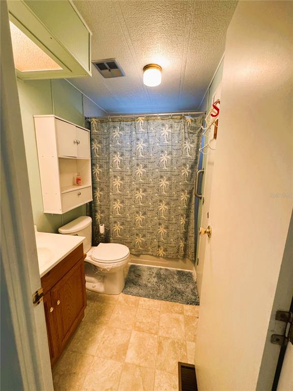 151 Hibiscus Way Leesburg, FL 34748 - Photo 16 of 30 a bathroom with a granite countertop sink toilet and shower