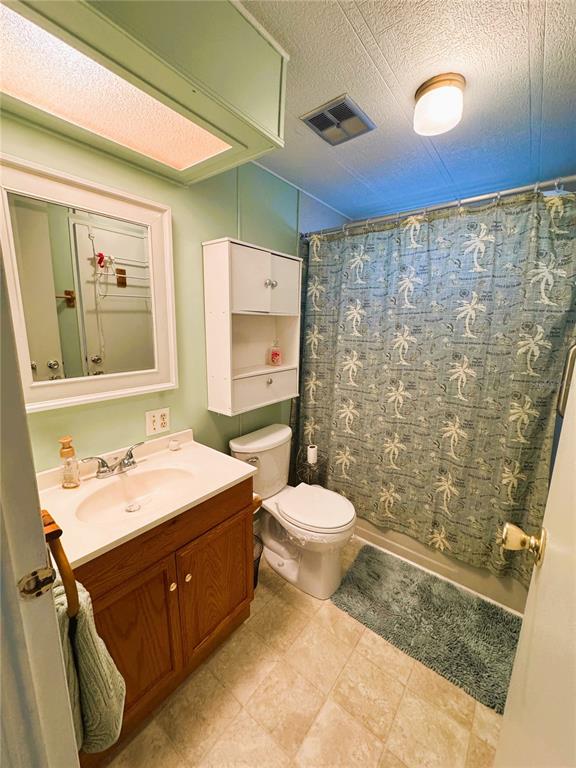 151 Hibiscus Way Leesburg, FL 34748 - Photo 17 of 30 a bathroom with a sink a toilet and shower