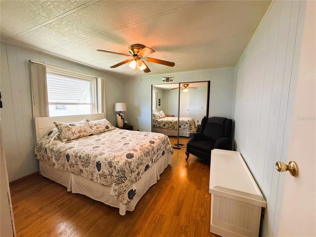 151 Hibiscus Way Leesburg, FL 34748 - Photo 19 of 30 a bedroom with a bed wooden floor and window
