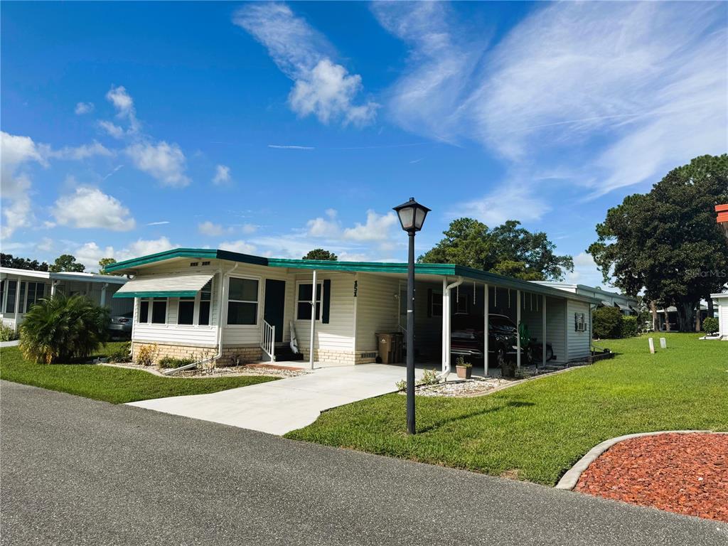 151 Hibiscus Way Leesburg, FL 34748 - Photo 2 of 30 a front view of a house with a yard