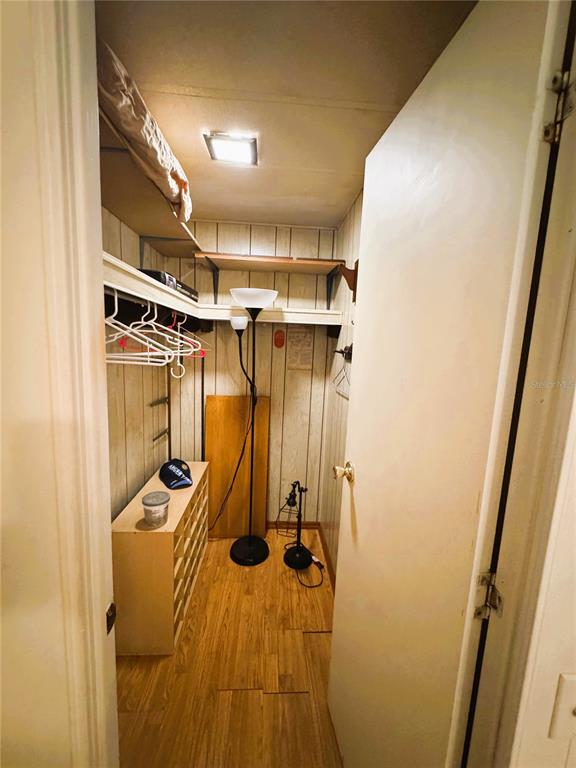 151 Hibiscus Way Leesburg, FL 34748 - Photo 24 of 30 a view of walk in closet with clothes and shoes