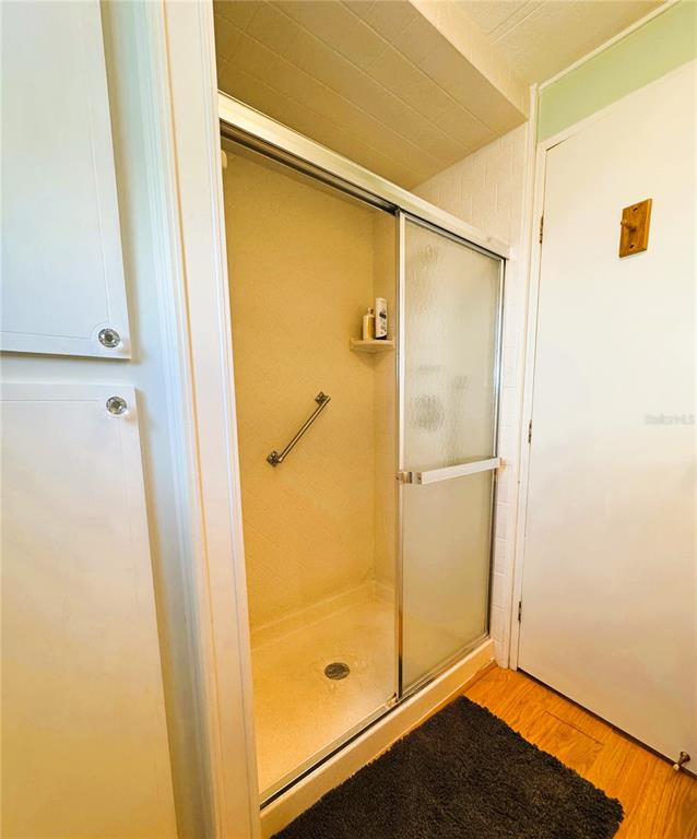 151 Hibiscus Way Leesburg, FL 34748 - Photo 26 of 30 a bathroom with a glass door shower