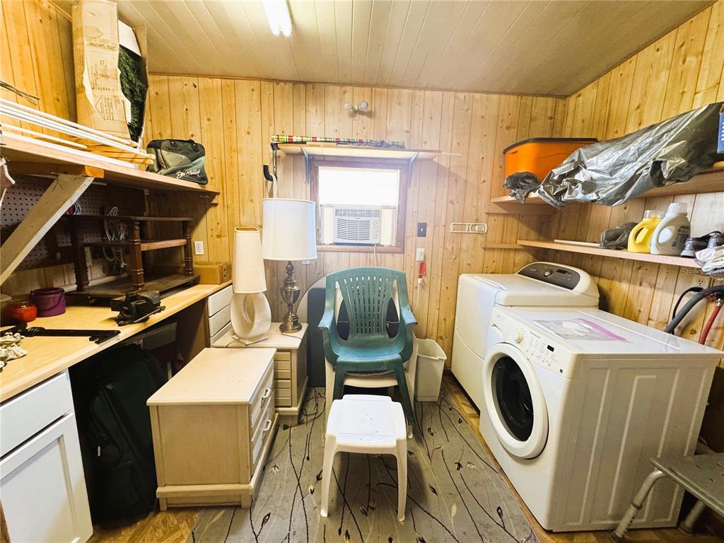 151 Hibiscus Way Leesburg, FL 34748 - Photo 29 of 30 a utility room with dryer washer and a view of living room