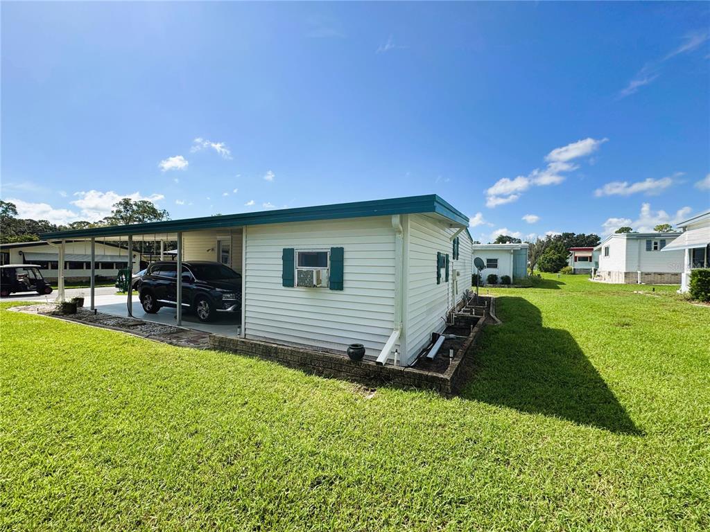 151 Hibiscus Way Leesburg, FL 34748 - Photo 30 of 30 a view of a backyard with sitting area