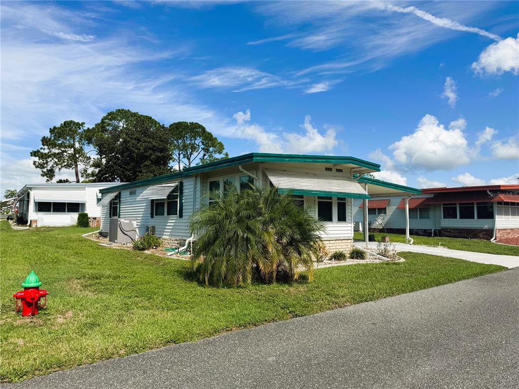 151 Hibiscus Way Leesburg, FL 34748 - Photo 3 of 30 a front view of house with yard and green space