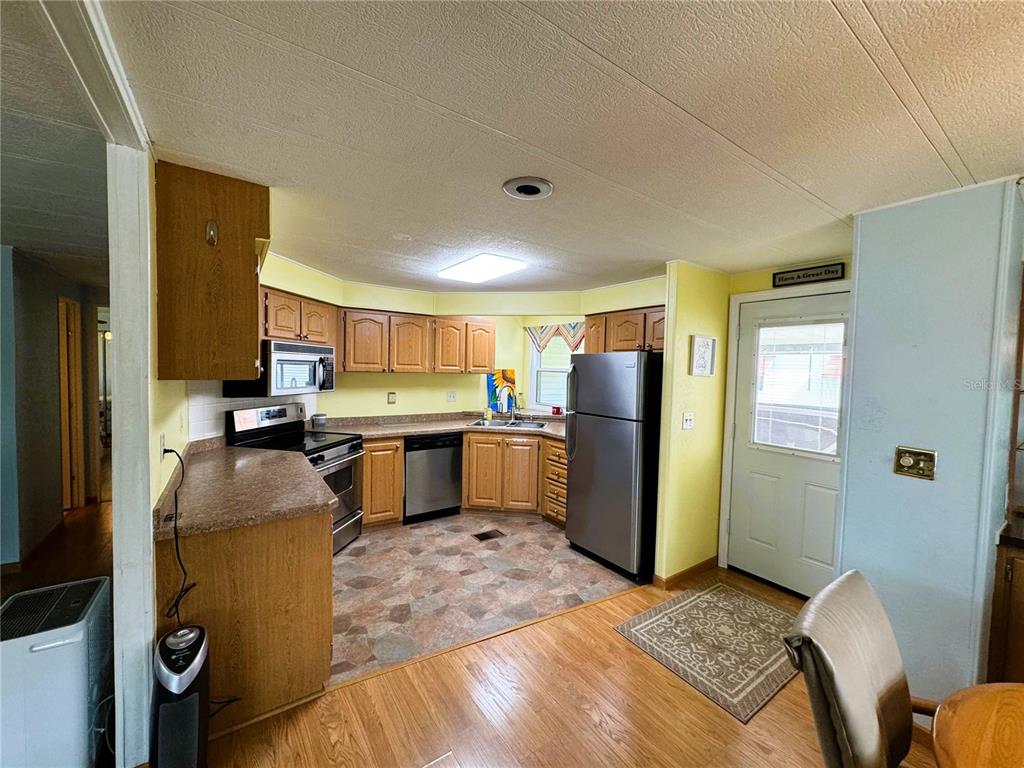 151 Hibiscus Way Leesburg, FL 34748 - Photo 5 of 30 a kitchen with a refrigerator and a sink