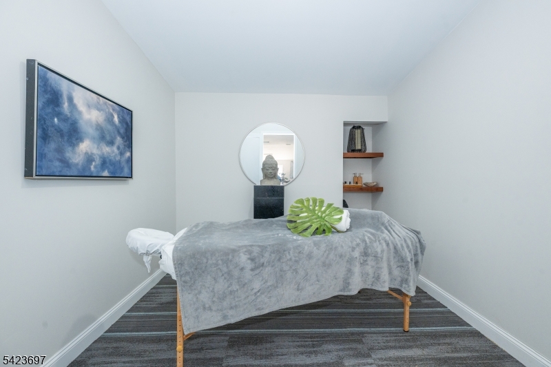 45 Village Road New Vernon, NJ 07976 - Photo 40 of 50 a bedroom with a bed and a table in it