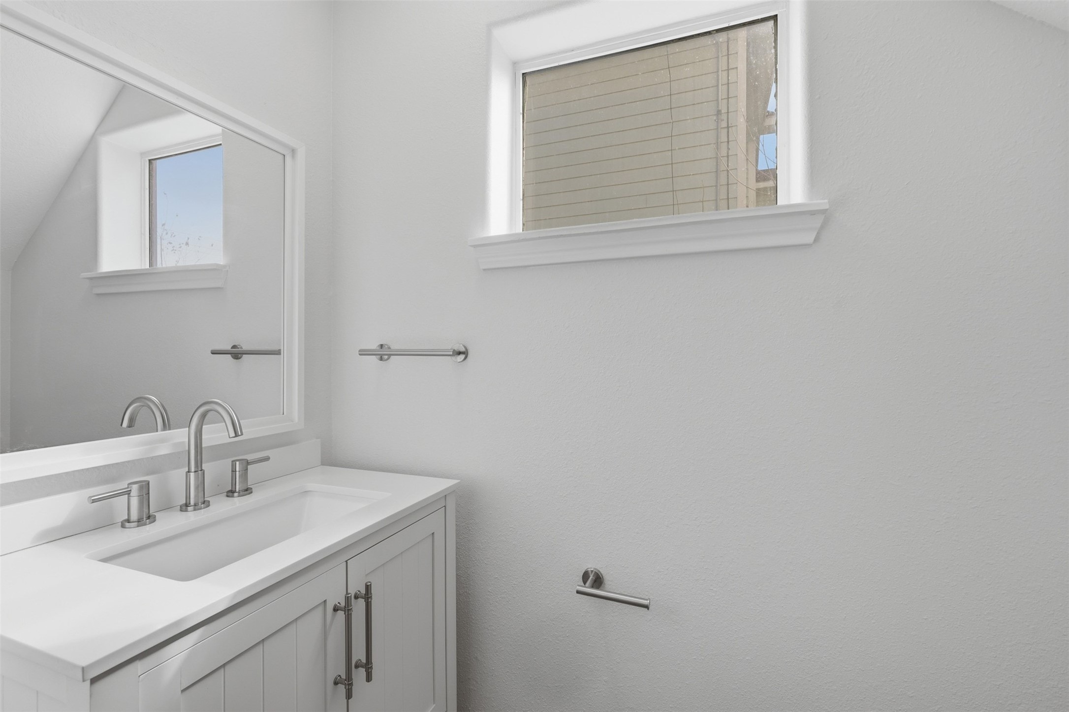 9026 McGallion Road Houston, TX 77022 - Photo 13 of 32 a bathroom with a sink and a vanity