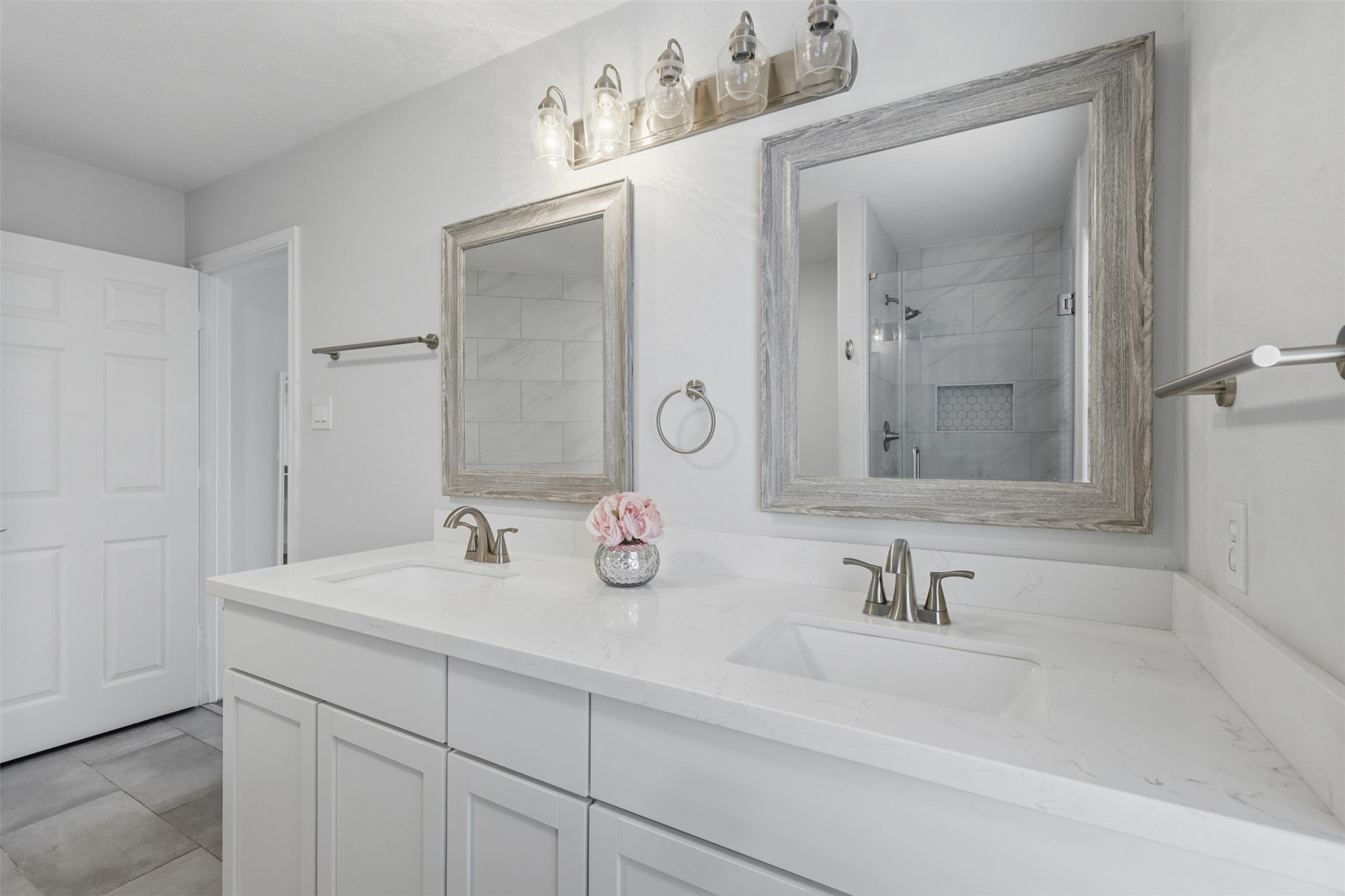 9026 McGallion Road Houston, TX 77022 - Photo 20 of 32 a bathroom with double vanity sinks and a mirror