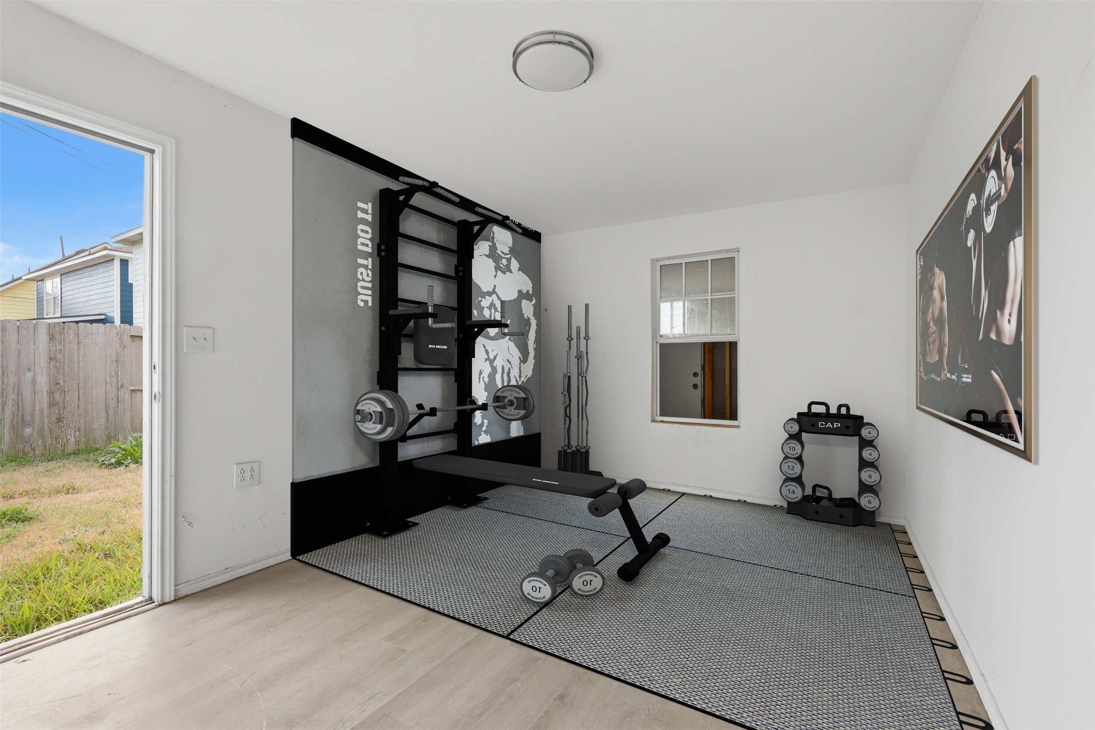 9026 McGallion Road Houston, TX 77022 - Photo 30 of 32 a room with gym equipment and a large window