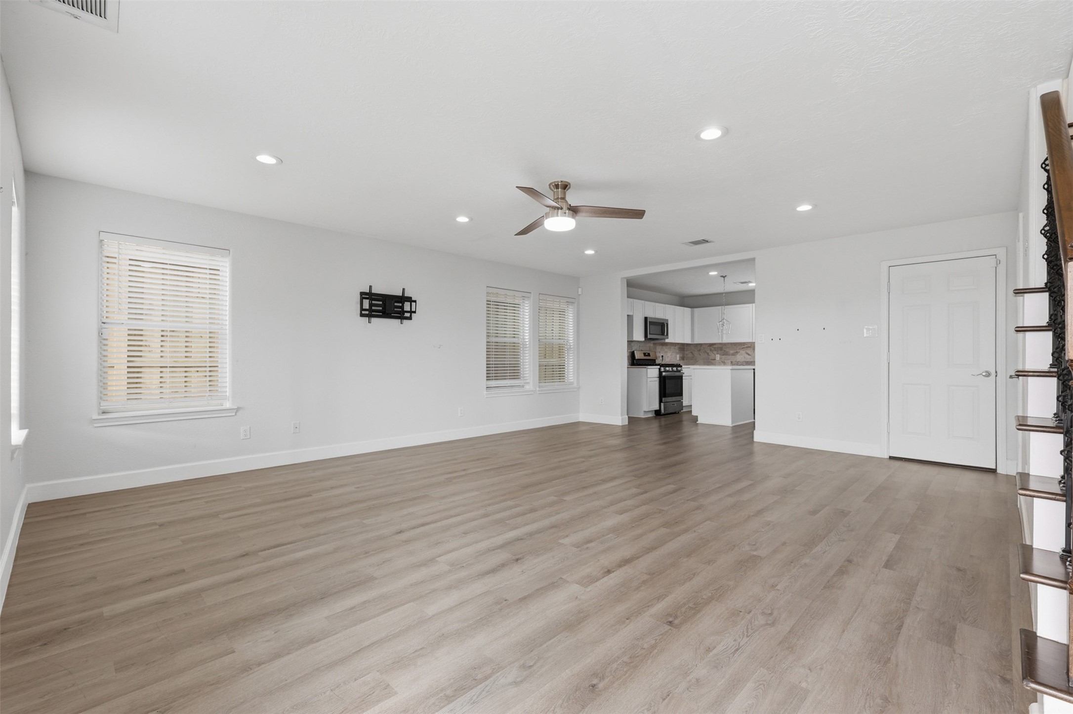 9026 McGallion Road Houston, TX 77022 - Photo 4 of 32 a view of empty room with wooden floor and a window