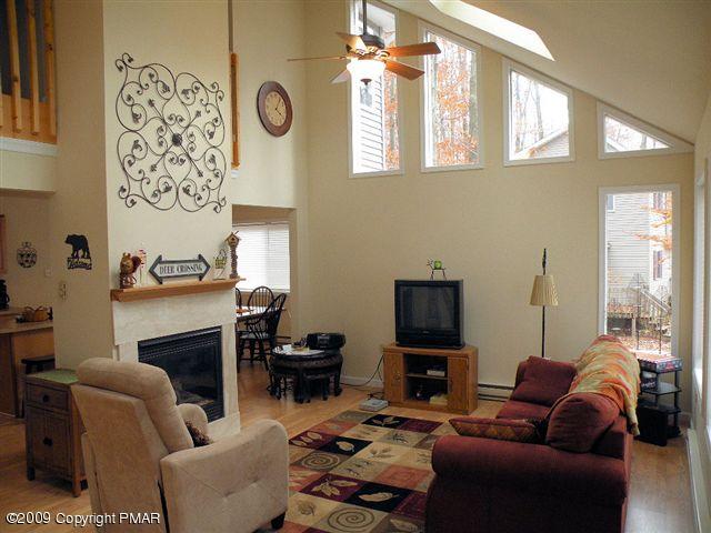 164 Elk Run Road Pocono Lake, PA 18347 - Photo 2 of 11 a living room with furniture a fireplace and a flat screen tv