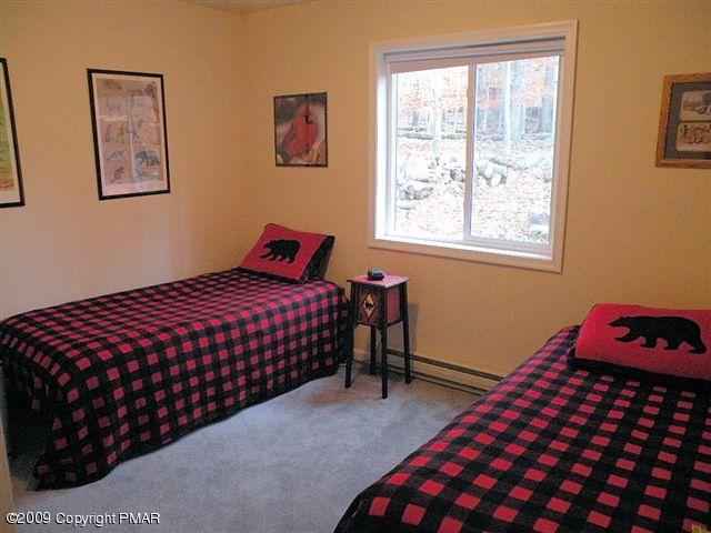 164 Elk Run Road Pocono Lake, PA 18347 - Photo 9 of 11 a bedroom with a bed and a window