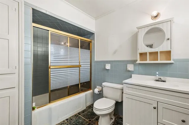 a bathroom with a toilet a sink and mirror