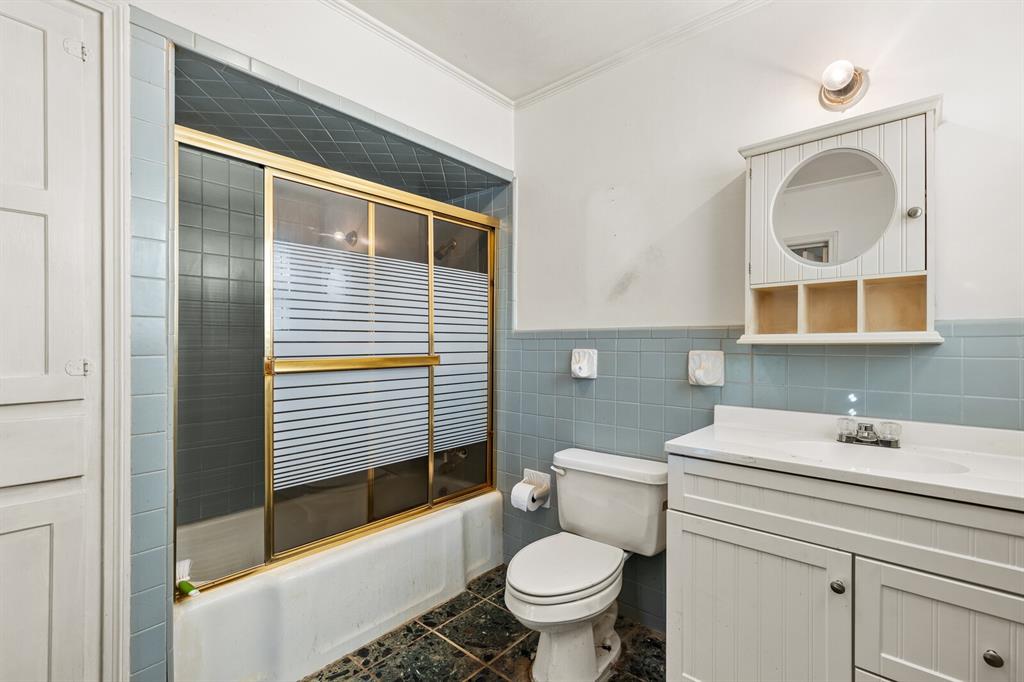 3120 Lyle Avenue Waco, TX 76708 - Photo 19 of 23 a bathroom with a toilet a sink and mirror