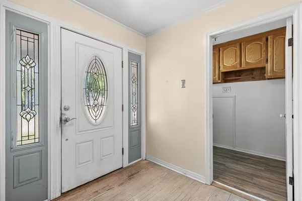 a view of a hallway with wooden floor
