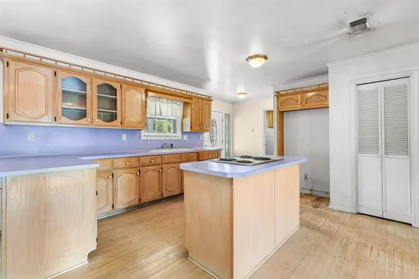 a kitchen with granite countertop a sink stove and refrigerator