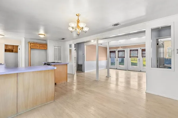 a view of an entryway with wooden floor and chandelier