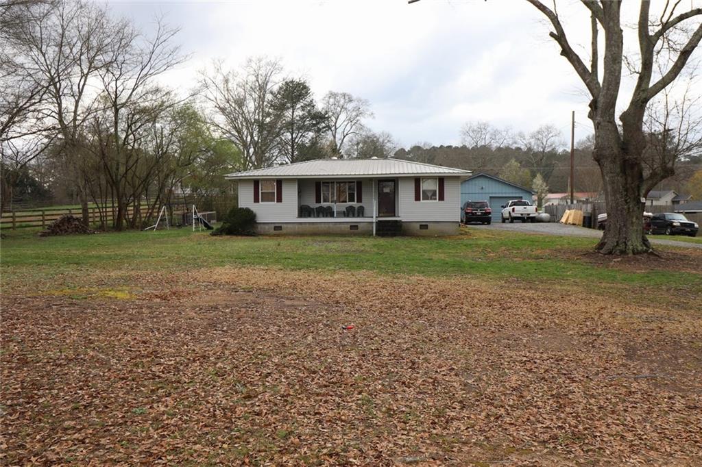 a view of a yard in front of a house with large trees