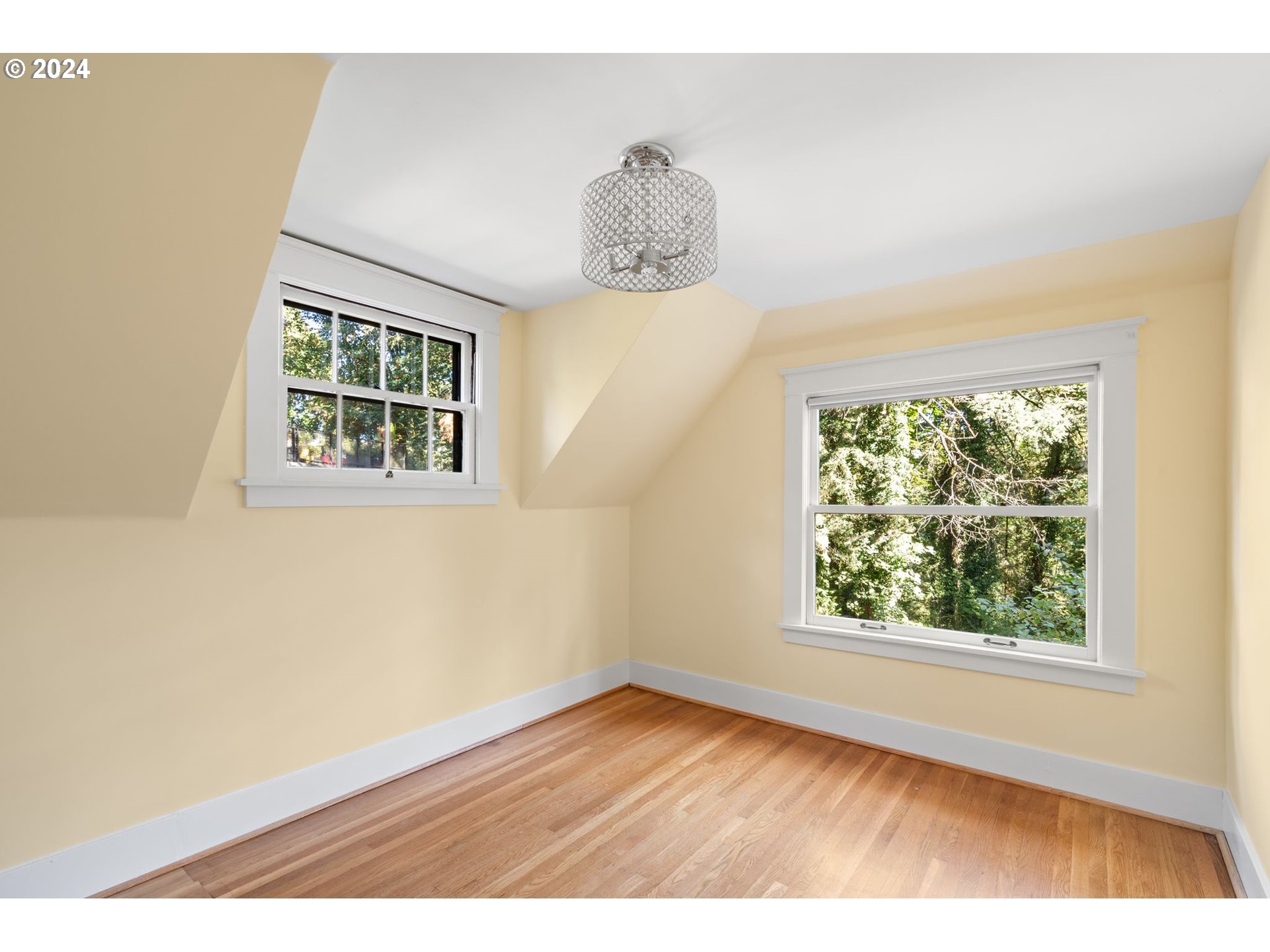 2770 Southwest Talbot Road Portland, OR 97201 - Photo 30 of 45 an empty room with wooden floor and windows
