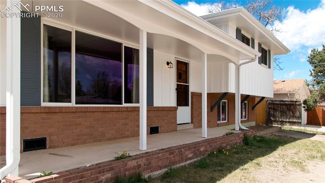 4027 Maxwell Road Colorado Springs, CO 80909 - Photo 3 of 35 Covered front porch with a raised patio, perfect size for a few chairs and a table to sit out and watch the world go by.