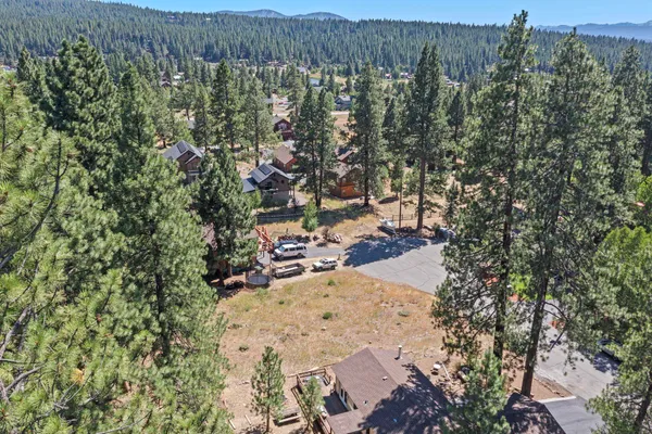 an aerial view of a house with a yard