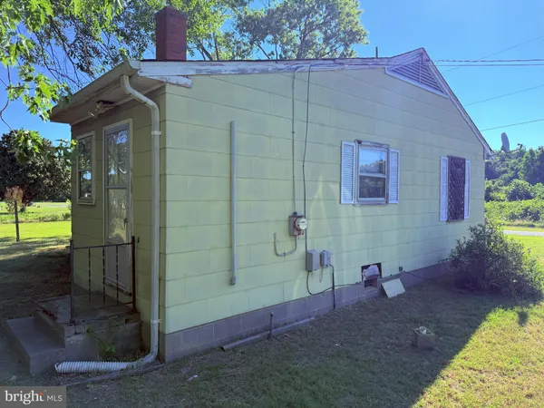 a view of a small house with potted plants