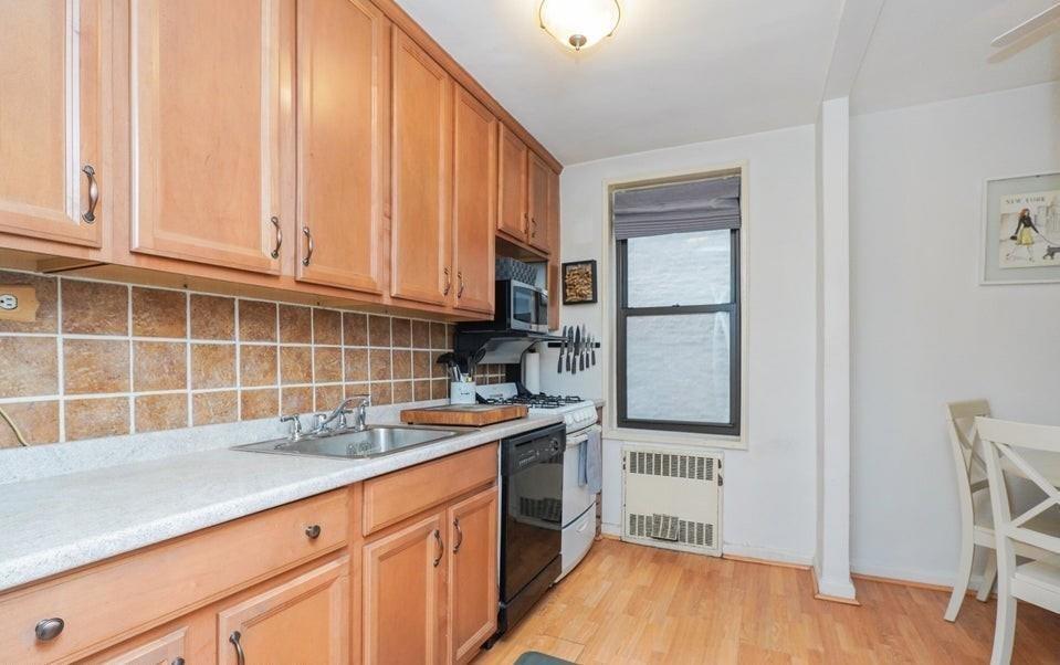 61 Oliver Street, Unit 2V Brooklyn, NY 11209 - Photo 12 of 23 a kitchen with stainless steel appliances granite countertop a stove a sink and a refrigerator